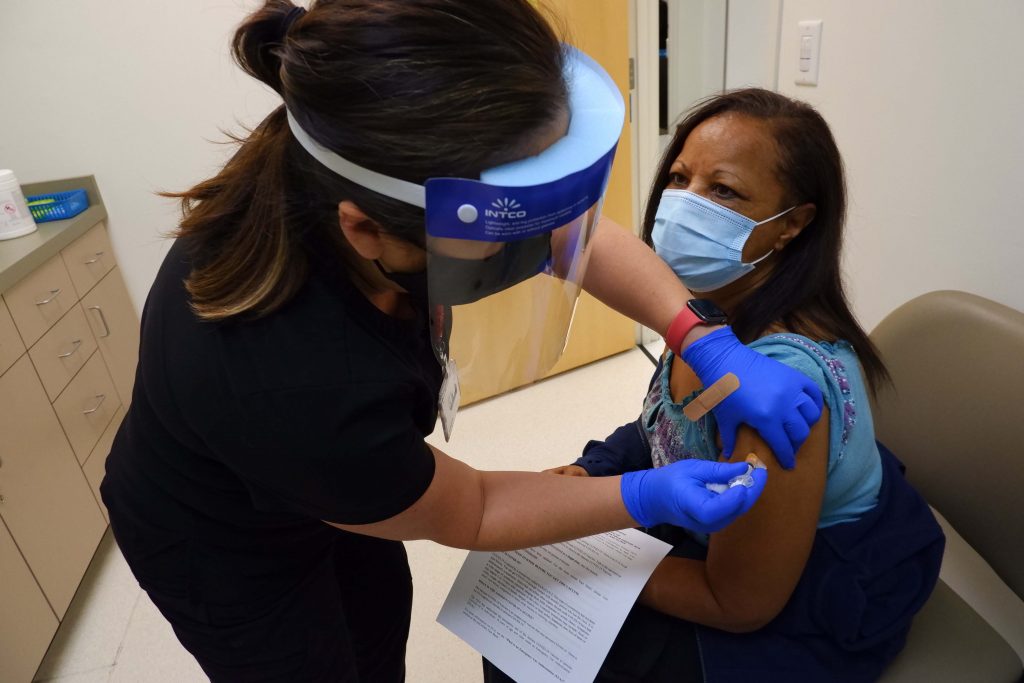 April Reya a medical assistant, gives the COVID-19 vaccination shot to Vicki Creighton, of Riverside, at the LaSalle Medical Associates medical office located in Rialto, Calif.  (Photo by Valda Wilson)