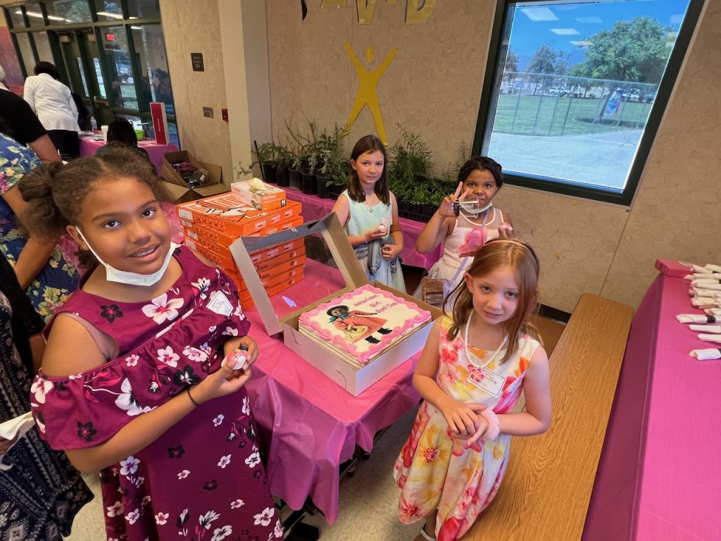 Photo caption: After a two-year Covid hiatus, families indulged in canapés, tea, cake, free plants, a book signing and new dolls with the American Girl Doll collection thanks to the San Bernardino City Library Foundation. The young ladies are ready to cut into the special cake for the American Girl Doll Tea Party.