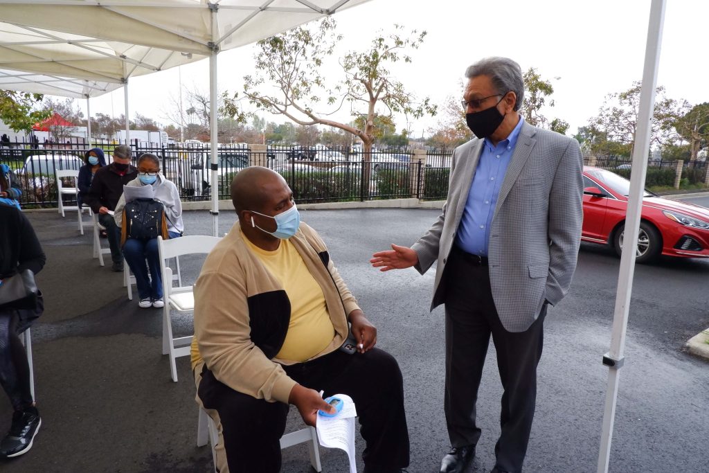 Dr. Albert Arteaga, president and founder of LaSalle Medical Associates, speaks with Baron Jordan, of San Bernardino, at the LaSalle Medical Associates medical office located in Rialto, Calif. Jordan is talking Dr. Arteaga about his healthcare. 