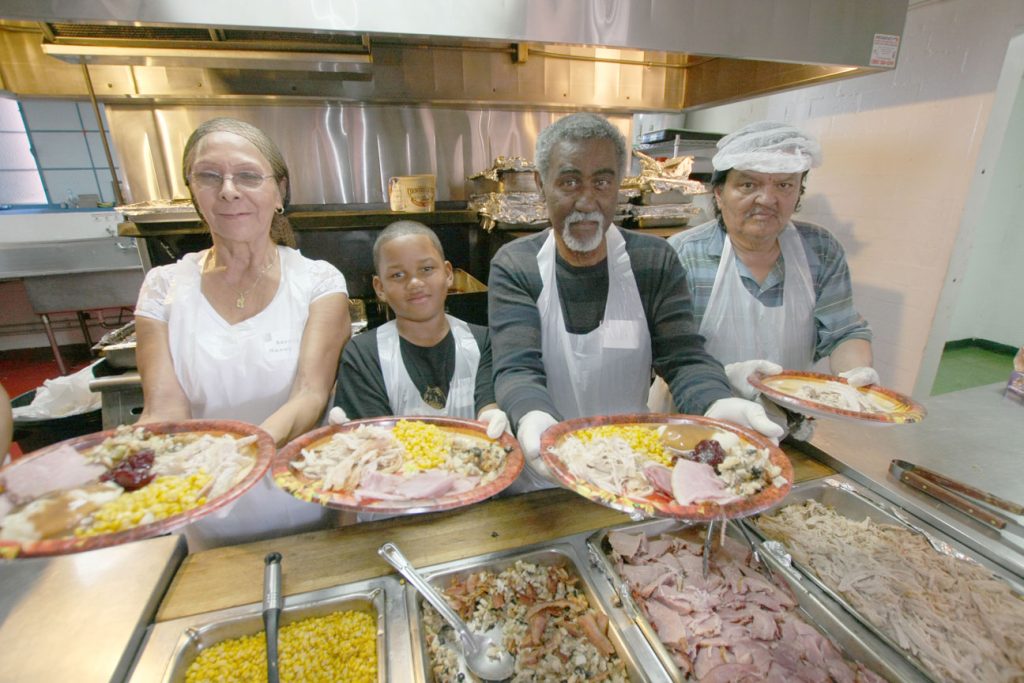 Volunteers serve Thanksgiving meals. The annual Thanksgiving meal brings in hundreds of families and individuals who do not have the means to provide themselves with a Thanksgiving dinner. The San Bernardino event serves about 200 people each year.