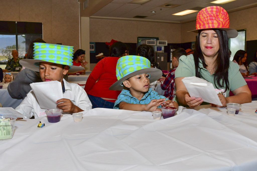 Tea party table-top crafts were a family affair.Left to right: Everhrda Gomez, Valentin Gomez and Maria Gomez. Photo by Chris Sloan 
