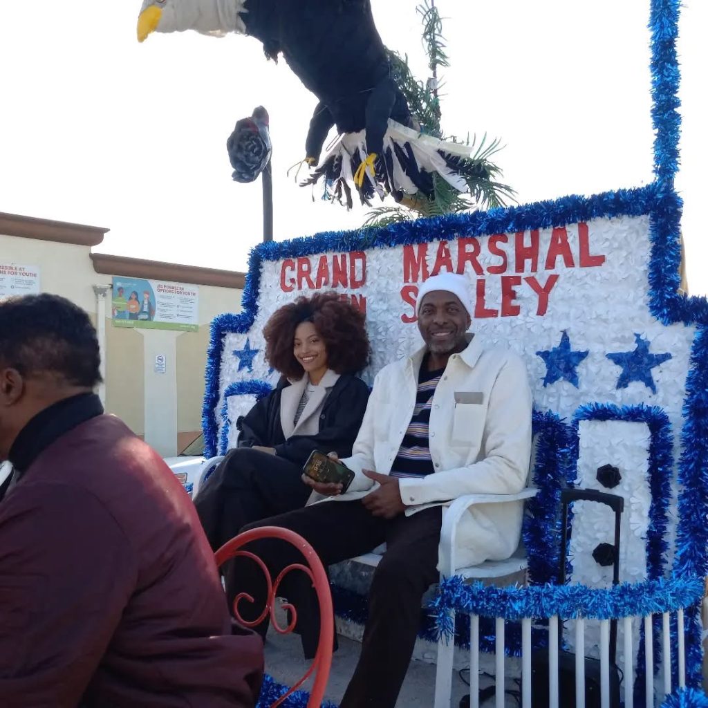 Black  History Parade Grand Marshal John Salley and his daughter. 