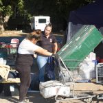 Photo Caption: Naomi Kuhlman talks with a homeless woman about her options for assistance. She and her spouse were camped out in Redlands Sylvan Park.